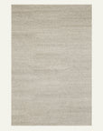The Aspen Rug - Fog by Armadillo&Co is a rectangular, light gray hand-knotted rug with a soft, subtle texture and no patterns, shown on a neutral background.