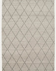 The Atlas Rug - Limestone by Armadillo&Co is a rectangular, light gray hand-knotted rug featuring a minimalist diamond pattern of dark lines, inspired by classic Moroccan Beni Ourain design.