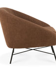The Ethnicraft Barrow Lounge Chair - Copper is a brown, vintage-inspired accent chair with a rounded back and slim black crisscross metal legs, displayed from the side on a white background.