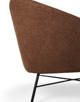 A close-up of the Ethnicraft Barrow Lounge Chair - Copper showcases its textured copper upholstery and sleek black metal legs, exuding a subtle vintage vibe against a plain white background.