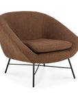The Barrow Lounge Chair - Copper by Ethnicraft features brown upholstery, a rounded back and seat, slim black metal legs, and an open minimalist design with subtle vintage appeal.