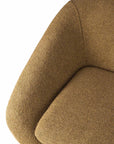 Close-up of the Ethnicraft Barrow Lounge Chair - Ginger, featuring textured light brown upholstery with a rounded backrest and armrest, showcasing its subtle vintage style against a white background.
