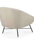 The Barrow Lounge Chair - Off White by Ethnicraft features a rounded backrest and black metal legs, showcasing modern style with a vintage touch. Shown from the back at an angle on a white background.