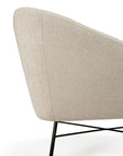 A close-up side view of the Ethnicraft Barrow Lounge Chair - Off White showcases its modern off-white textured fabric and slim black metal legs, adding a vintage touch to any space, set against a plain white background.
