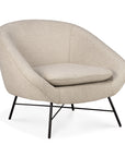 The Ethnicraft Barrow Lounge Chair in Off White features a modern design with a rounded backrest, wide seat cushion, and slim black metal legs for a subtle vintage vibe.