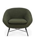 The Barrow Lounge Chair - Pine by Ethnicraft features a modern rounded back and seat in pine green, complemented by slender black metal legs with intersecting supports, giving it a vintage flair against a white background.
