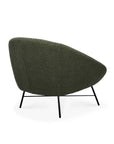 The Ethnicraft Barrow Lounge Chair - Pine features a rounded back, sleek black metal legs, and is shown in pine green fabric from a rear side angle against a white background, offering a modern seat with vintage flair.