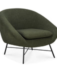 The Barrow Lounge Chair - Pine by Ethnicraft features modern dark green fabric, a curved back and seat, slim black metal legs, and a minimalist design—adding subtle vintage charm to any room.