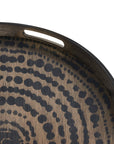 Close-up of the Ethnicraft Black Beads Wooden Tray - Round / Small, showcasing its dark, silk-screen printed dotted circular pattern and an oval cutout handle near the edge.