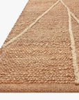 Close-up of the Bodhi Rug - Natural / Ivory Abstract by Loloi, featuring thick, textured jute fibers and cream abstract lines on a natural brown background.
