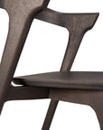 Close-up of the Ethnicraft Bok Dining Chair - Brown Oak, highlighting its solid oak seat and angular backrest with smooth surfaces and clean, minimalist lines.