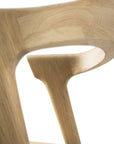 Close-up of the Ethnicraft Bok Dining Chair - Oak, highlighting the smooth, curved backrest and visible natural grain in solid oak, set against a white background.