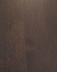 Close-up of the Bok Dining Table by Ethnicraft, crafted from dark brown European oak with visible grain patterns and subtle texture, highlighting the table’s natural color variations and unique lines.