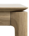 Close-up of the Ethnicraft Bok Dining Table - Oak, showing smooth, rounded edges and natural European oak grain with a seamless join between tabletop and leg.