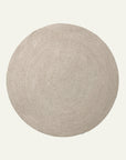 The Armadillo&Co Braid Rug - Mushroom is a round, beige wool-blend rug featuring a simple textured pattern, showcased on a plain white background.