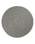 The Armadillo&Co Braid Rug - Pumice is a round, gray wool-blend rug featuring a textured surface and simple, neutral design. Photographed against a white background, it captures the timeless charm of handmade rugs.