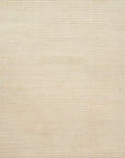 The Cadence Rug - Beige by Loloi features a minimalist wool pattern with subtle, evenly spaced horizontal lines and a hand-knotted, textured beige surface.