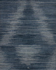 A textured surface with horizontal, uneven dark and light gray lines creates a subtle, abstract pattern reminiscent of the Loloi Cadence Rug - Navy.