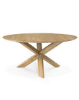 The Ethnicraft Circle Dining Table - Oak features a smooth European oak top and an intersecting crisscross base, showcasing elegant design against a plain white background.