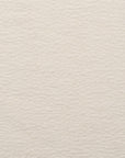 A close-up of a textured, off-white surface reveals the subtle irregular patterns featured in Natadora + Tolv Material Swatches, each custom made-to-order for the perfect sample.