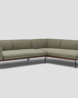 The Department Modular Sofa | Fabric • M6 by Wooden Stories features olive green cushions, slim black metal legs, and a solid wood frame inspired by Danish design, shown here against a light gray background.