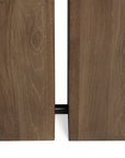 Close-up of two vertically aligned, unfinished natural teak panels with a narrow gap exposing a black metal rod—part of Ethnicraft’s Double Extendable Dining Table.