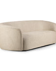 The Ethnicraft Ellipse Sofa - Oatmeal is a modern, curved sofa with smooth upholstery, no visible legs, and a low back and armrests that form a continuous line around the seat.