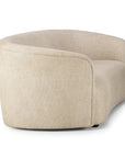 The Ethnicraft Ellipse Sofa - Oatmeal features a curved, modern design with smooth, rounded edges and a low backrest, shown from an angled rear side view on a plain white background.
