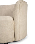 Close-up side view of the Ethnicraft Ellipse Sofa - Oatmeal, showcasing modern beige fabric with rounded, cushioned armrest and backrest, set against a white background.