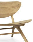 Close-up of the Ethnicraft Eye Lounge Chair - Oak, showcasing its smooth, curved backrest and seat in light European oak. The partial view emphasizes the minimalist design and elegant wood grain.