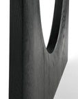 Close-up of a dark, rectangular wooden structure crafted from solid black oak, featuring a smooth, semi-circular cutout that highlights the wood grain—a refined detail echoing Ethnicrafts Geometric Dining Table - Black.