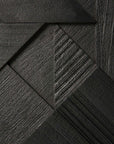 Close-up of a dark, textured geometric pattern formed by interlocking wood-like panels in varied grain, inspired by the Ethnicraft Graphic Sideboard - 3 door for a modern and angular design.