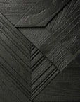 The Graphic Sideboard - 3 door by Ethnicraft features a geometric pattern of overlapping black textured panels with wood grain and diagonal lines, creating a layered, abstract design reminiscent of the brands signature style.