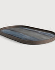 The Ethnicraft Graphite Organic Glass Tray (Oblong/Medium) features a glossy wavy blue and gray resin inlay on its base and rounded corners, shown on a white background.