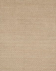 A close-up of the Hadley Rug - Dune by Loloi shows its beige woven fabric, subtle repetitive square pattern, and soft hand-cut pile texture.