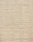 The Hadley Rug - Natural by Loloi features a beige grid pattern with horizontal and vertical lines, each rectangular section enhanced by hand-cut pile for a simple, textured look.