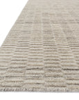 Close-up of the Loloi Hadley Rug - Oatmeal, showing its light beige textured surface, subtle rectangular grid pattern, and hand-cut pile with a soft, slightly raised finish and thin edge.