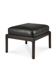 The Jack Footstool by Ethnicraft features a black leather rectangular cushion and dark mahogany-finished wooden legs, inspired by Scandinavian modernism, shown against a white background.