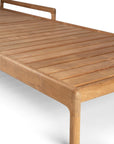 A close-up of the Ethnicraft Jack Outdoor Adjustable Lounger in teak shows its slatted seat, rounded edges, and minimalist design with clean lines and a smooth finish, set against a white background.