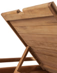 A close-up of the Ethnicraft Jack Outdoor Adjustable Lounger - Teak shows its slatted teak lid propped open with a support arm, revealing the inner construction and natural wood grain—ideal for any outdoor space.