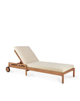 The Ethnicraft Jack Outdoor Adjustable Lounger in teak features beige cushions, an adjustable backrest, and two small back wheels for easy movement, shown against a white background.