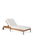 The Jack Outdoor Adjustable Lounger by Ethnicraft features a teak frame, white cushioned seat and backrest, adjustable reclining positions, and two small wheels at one end for easy movement.