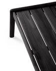Close-up of the Jack Outdoor Coffee Table in black teak by Ethnicraft, featuring clean lines and angled legs in a modern slatted design, set against a white background.