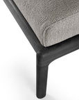 Close-up of the Ethnicraft Jack Outdoor Footstool, showing its textured mocha cushion and smooth black teak frame and leg, set against a white background.