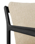 Close-up of the Ethnicraft Jack Outdoor Lounge Chair, featuring a natural textured beige cushion and a sleek black teak frame with smooth, modern lines.