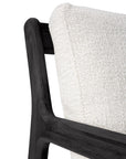 Close-up of the Ethnicraft Jack Outdoor Lounge Chair in black teak with an off-white cushion, highlighting where the cushion meets the armrest and backrest for a sophisticated outdoor lounge look.