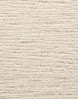 Close-up of a textured beige carpet from Natadora + Tolv's Material Swatches, featuring horizontal ridges and a soft, cozy surface—perfect for custom made-to-order designs or pairing with fabric swatches.