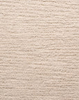 Close-up of Material Swatches by Natadora + Tolv, featuring a beige, textured carpet with horizontal ridges. The soft woven look and subtle color depth make these swatches ideal for custom made-to-order fabric coordination.