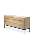 The Ethnicraft Ligna Sideboard features three doors and three drawers in light natural European oak, set on slim black metal legs—a modern, elegant storage solution blending classic refinement.