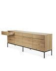 The Ethnicraft Ligna Sideboard features a modern design in European oak with a light natural finish, four doors, four drawers, and slim black metal legs.